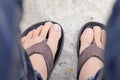 Feet of men wearing black sandals