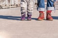 Feet of mom and baby in shoes. They are ready to travel. concept of road of life