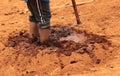 Feet in mud to prepare wet slurry