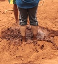 Feet in mud to prepare wet slurry Royalty Free Stock Photo