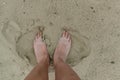 Feet naked barefoot without shoes burrow in the sand on a sandy beach, white skin Royalty Free Stock Photo