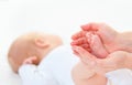 Feet newborn baby in arms him mother Royalty Free Stock Photo