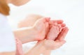 Feet newborn baby in arms him mother Royalty Free Stock Photo