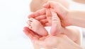 Feet newborn baby in arms him mother Royalty Free Stock Photo