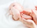 Feet newborn baby in arms him mother