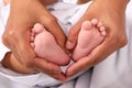 Feet of newborn baby boy in hands Royalty Free Stock Photo