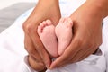 Feet of newborn baby boy in hands Royalty Free Stock Photo