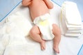 Feet of newborn baby on changing table with diapers. Cute little girl or boy two weeks old. Dry and healthy body and Royalty Free Stock Photo