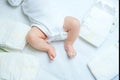 Feet of newborn baby on changing table with diapers. Cute little girl or boy two weeks old. Dry and healthy body and Royalty Free Stock Photo