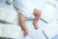 Feet of newborn baby on changing table with diapers. Cute little girl or boy two weeks old. Dry and healthy body and Royalty Free Stock Photo