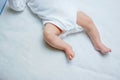 Feet of newborn baby on changing table with diapers. Cute little girl or boy two weeks old. Dry and healthy body and Royalty Free Stock Photo