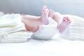 Feet of newborn baby on changing table with diapers Royalty Free Stock Photo