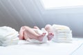 Feet of newborn baby on changing table with diapers Royalty Free Stock Photo