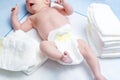 Feet of newborn baby on changing table with diapers Royalty Free Stock Photo