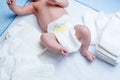 Feet of newborn baby on changing table with diapers Royalty Free Stock Photo