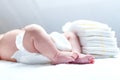 Feet of newborn baby on changing table with diapers Royalty Free Stock Photo