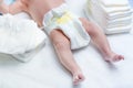 Feet of newborn baby on changing table with diapers Royalty Free Stock Photo