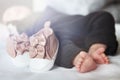 Feet of newborn baby. Footwear and baby shoe. Beautiful conceptual image of motherhood. Royalty Free Stock Photo