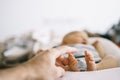 The feet of a newborn baby lying in Baby Cocoon and his fathers hands Royalty Free Stock Photo