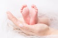 Feet of Newborn Baby, Mother Holding New Born Kid Legs on Hand Royalty Free Stock Photo