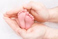 Feet of Newborn Baby, Mother Holding New Born Kid Legs in Hand Royalty Free Stock Photo