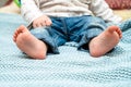 Feet of newborn baby, one-year-old baby, denim suit Royalty Free Stock Photo