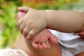 Feet of a newborn baby in the palms of a baby.  Close-up of a baby hand holding the foot of a newborn, close-up, place for text Royalty Free Stock Photo