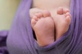 Feet of a newborn baby, toes of a child, the first days of life after birth, scaly skin
