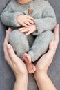 Feet of a newborn baby, toes in the hands of mom and dad, hands and nails of a child, the first days of life after birth. Royalty Free Stock Photo