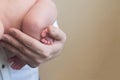 Feet of a newborn baby, toes in the hands of mom and dad, hands and nails of a child, the first days of life after birth, Royalty Free Stock Photo