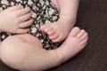 Feet of a newborn baby, toes in the hands , hands and nails of a child, the first days of life after birth, scaly skin Royalty Free Stock Photo