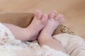 Feet of a newborn baby, toes  and nails of a child, the first days of life after birth, scaly skin, funny splayed toes Royalty Free Stock Photo