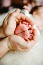 The feet of the newborn in the hands of the Pope