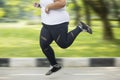 Feet of obese woman sprinting on the road Royalty Free Stock Photo