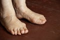 feet of an old grandmother on a dirty wooden floor, loneliness, feet of an old man, a pensioner