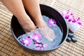 Feet in orchid spa bowl Royalty Free Stock Photo