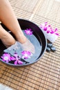 Feet in orchid spa bowl Royalty Free Stock Photo