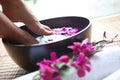 Feet in orchid spa bowl Royalty Free Stock Photo