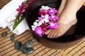 Feet in orchid spa bowl Royalty Free Stock Photo