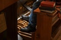 Feet of an organist playing on the organ pedals, traditional musical instrument in the church, copy space, selected focus Royalty Free Stock Photo