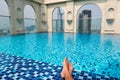 Feet over the sparkling pool on top of building with Saigon aerial view Royalty Free Stock Photo