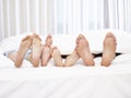 Feet of parents and children in bed Royalty Free Stock Photo