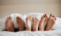 Feet, parents and kid sleeping on bed to relax with love, rest or sleeping on hotel mattress in morning. People Royalty Free Stock Photo