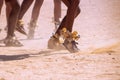 Feet of a person dancing in the sand