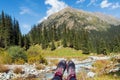Feet of a person lying on a meadow in the mountains. First person view.