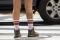 Feet of a person wearing rainbow-colored socks