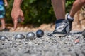 Petanque player pointing at the ground, holding a steel ball Royalty Free Stock Photo