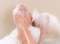 Feet relaxing in soapy bubble bath tub Royalty Free Stock Photo