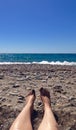 Feet resting in the sand on the beach Royalty Free Stock Photo