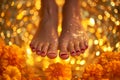 feet rising out of a shimmering gold soak with marigold flowers